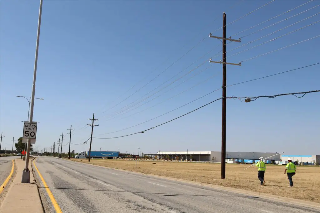 Wood distribution poles with crossarms and utility attachments